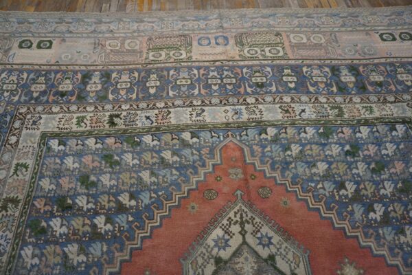 Close-up of the patterned field and border of an antique rug by rugs on net. By rugs on net