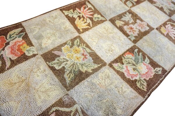 Close-up of a checkerboard rug featuring floral motifs in brown squares, by rugs on net. By rugs on net