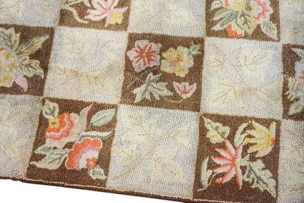 Close-up of a checkerboard patterned rug featuring floral motifs in brown squares, by rugs on net. By rugs on net