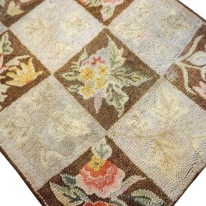 Close-up of a hooked rug featuring a checkerboard pattern with floral motifs in brown diamonds, by Rugs On Net. by Rugs On Net