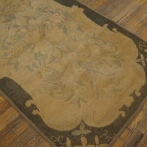 Close-up of a beige and green floral rug on a wooden floor by Rugs On Net