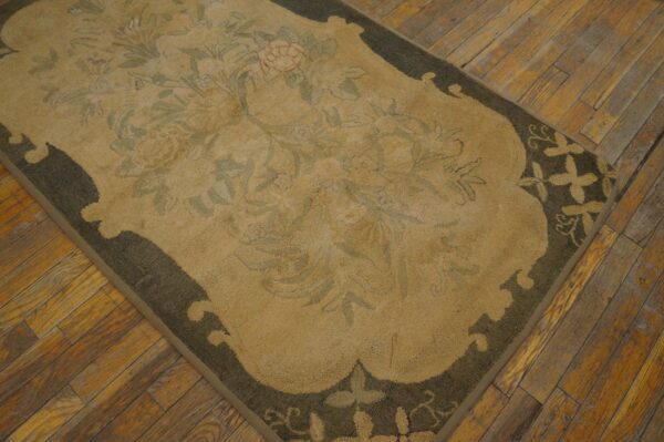 Close-up of a beige and green floral rug on a wooden floor by rugs on net