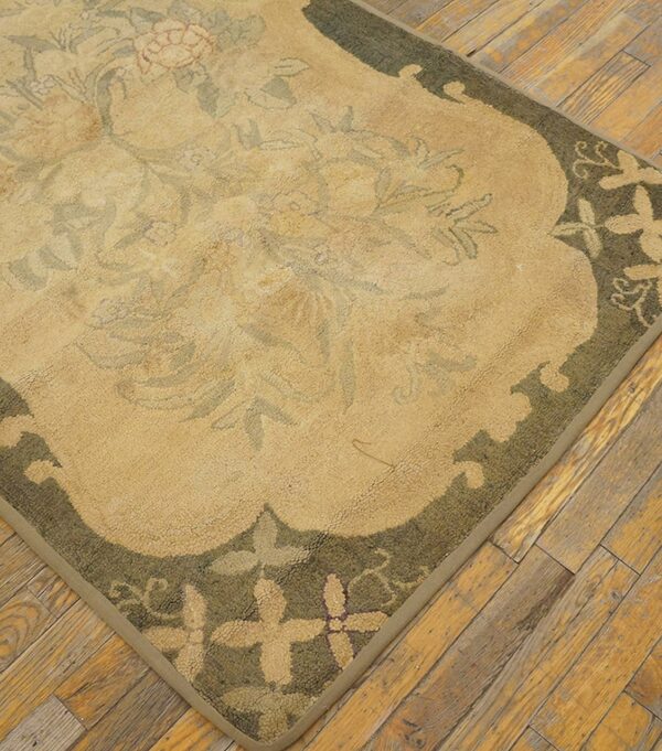 Close-up of a beige and olive green floral rug corner on wood flooring by rugs on net