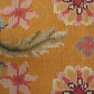 Close-up of a vibrant orange rug with pink and blue floral details, by Rugs On Net