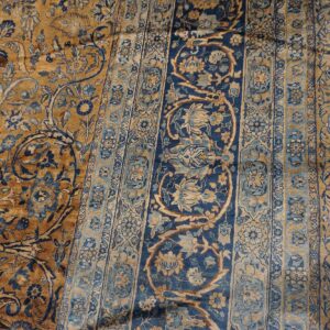 Close-up of a gold and blue floral pattern on a vintage rug by Rugs On Net