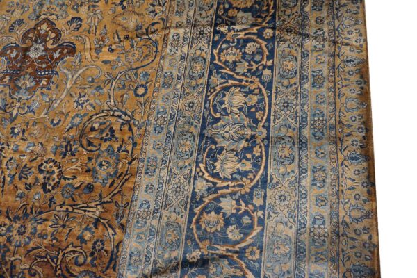 Close-up of a gold and blue floral pattern on a vintage rug by rugs on net