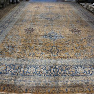 Large antique rug with gold and blue floral patterns by Rugs On Net