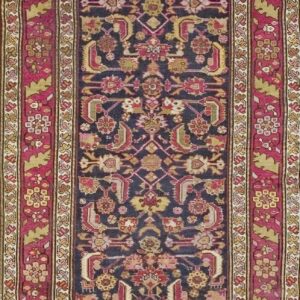 Close-up of a dark field rug with magenta borders, featuring geometric and floral motifs, by Rugs On Net