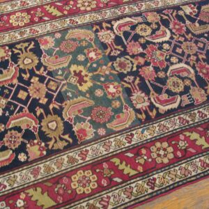 Close-up of a richly colored rug with geometric and floral motifs in navy, red, and teal, by Rugs On Net. by Rugs On Net