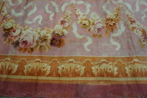 Close-up of a pink floral rug with ribbon accents by rugs on net. By rugs on net