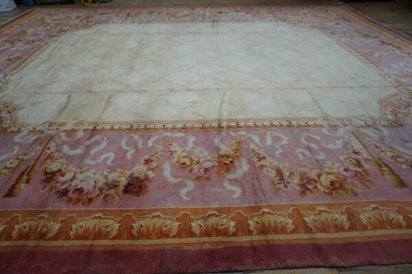 Close-up of a pink and cream floral rug with a faded center by rugs on net