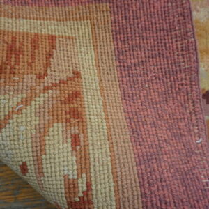 Close-up texture shot of the corner of a multicolored rug, showing woven detail by Rugs On Net. by Rugs On Net