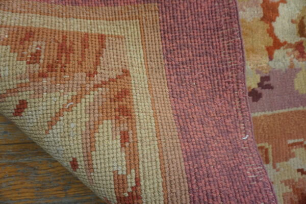 Close-up texture shot of the corner of a multicolored rug, showing woven detail by rugs on net. By rugs on net