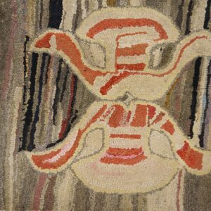 Close-up of an abstract motif in a hooked rug, featuring beige and orange shapes against a variegated brown background, by Rugs On Net. by Rugs On Net