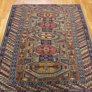 A vibrant geometric runner rug with red, blue, and beige patterns on a light wood floor by Rugs On Net. by Rugs On Net