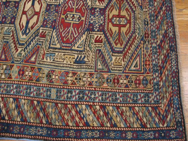 Close-up of geometric patterns on the kazak rug by rugs on net. By rugs on net