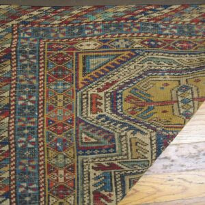 Close-up corner detail of a richly patterned antique rug featuring geometric borders and earthy tones by Rugs On Net. by Rugs On Net