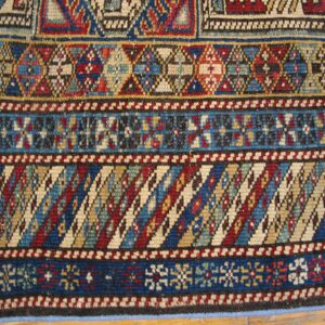 Close-up of geometric patterns on a colorful tribal rug by Rugs On Net