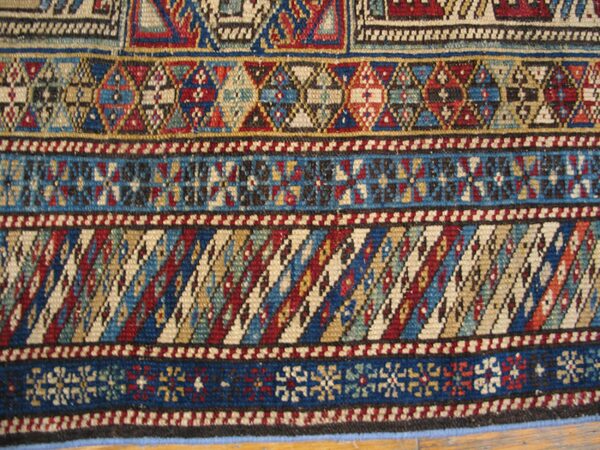 Close-up of geometric patterns on a colorful tribal rug by rugs on net
