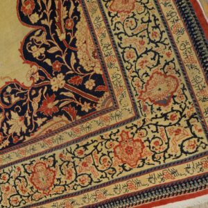 Close-up of a traditional rug corner featuring cream, navy, and red floral patterns by Rugs On Net. by Rugs On Net