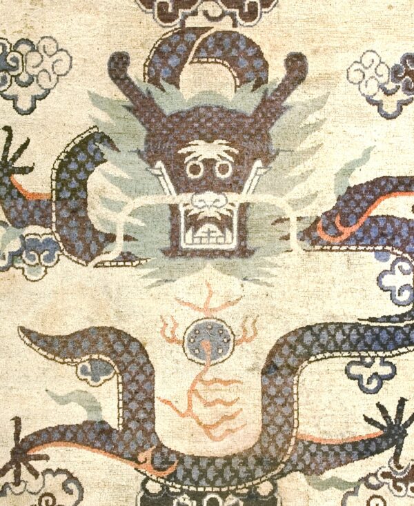 Close-up of a dragon motif on an antique rug by rugs on net