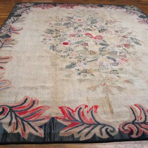 Close-up of a light-colored rug with scattered floral motifs and a bold border, by Rugs On Net
