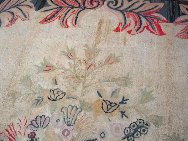 Close-up of a light-colored rug featuring faded floral motifs and a decorative border, by rugs on net