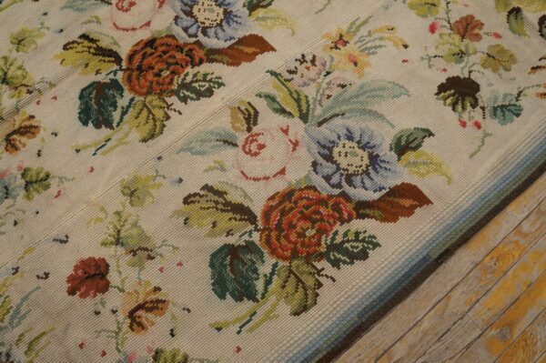 Close-up of a floral needlepoint rug with cream background and colorful blooms by rugs on net