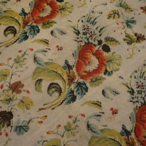 Close-up of a floral needlepoint rug with red roses and green foliage on a cream background by Rugs On Net