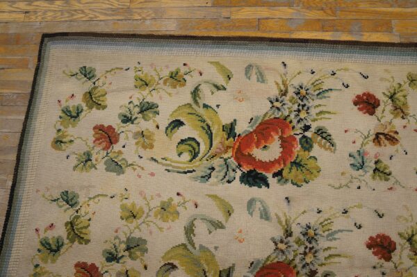 Close-up of a floral needlepoint rug with red and green accents on a light background, by rugs on net. By rugs on net