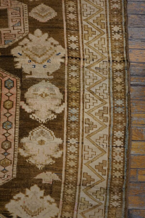 Close-up of a brown and beige geometric pattern on an antique rug by rugs on net. By rugs on net