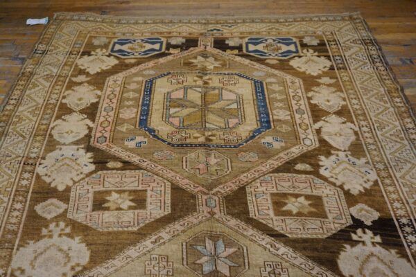 Close-up view of a geometric brown and beige rug pattern by rugs on net