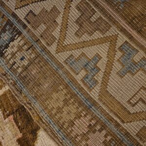 Close-up of the woven texture and geometric patterns in shades of brown and beige of the 'Antique Tribal Kilim' by Rugs On Net. by Rugs On Net
