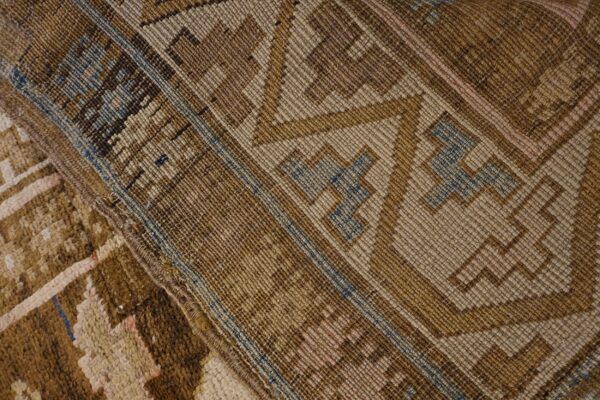 Close-up of the woven texture and geometric patterns in shades of brown and beige of the 'antique tribal kilim' by rugs on net. By rugs on net