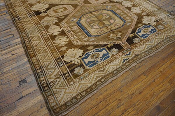 Close-up of a brown and blue patterned rug corner on a wooden floor by rugs on net