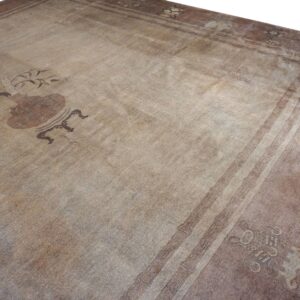 Close-up of a faded, antique rug with subtle brown motifs, by Rugs On Net