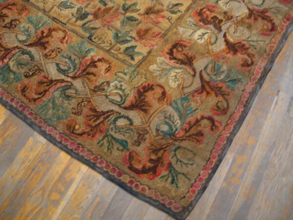 Close-up corner detail of a richly colored, traditional rug with floral motifs on a tan ground, by rugs on net. By rugs on net