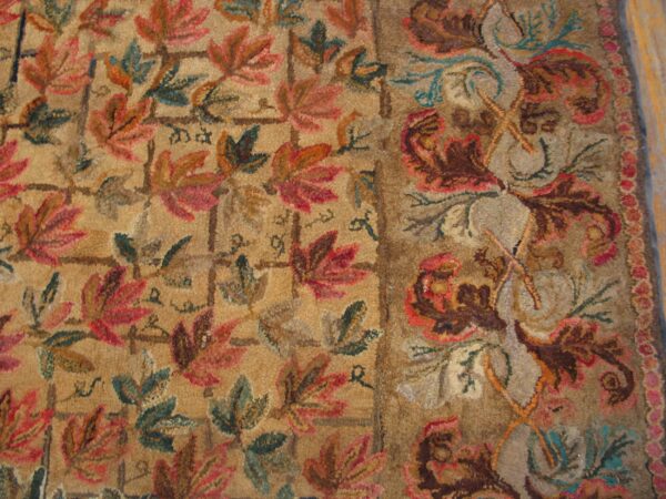 Close-up of a richly textured rug featuring autumnal leaf patterns in reds, greens, and browns on a tan ground, by rugs on net