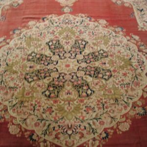 Close-up of a red Oriental rug with a central medallion design by Rugs On Net. by Rugs On Net