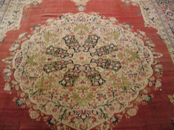 Close-up of a red oriental rug with a central medallion design by rugs on net. By rugs on net