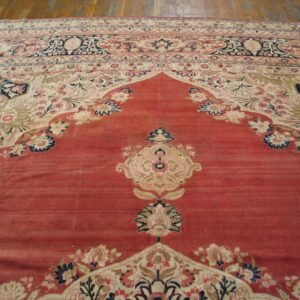 Close-up view of a red and cream Oriental rug with intricate floral borders by Rugs On Net. by Rugs On Net
