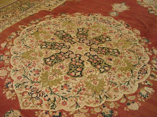 Close-up view of the intricate central medallion and floral design of the persian rug by rugs on net. By rugs on net