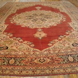 Large antique Persian rug with a red field and intricate floral borders by Rugs On Net