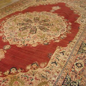 Close-up view of a richly colored red rug with intricate floral patterns and a large central medallion, by Rugs On Net
