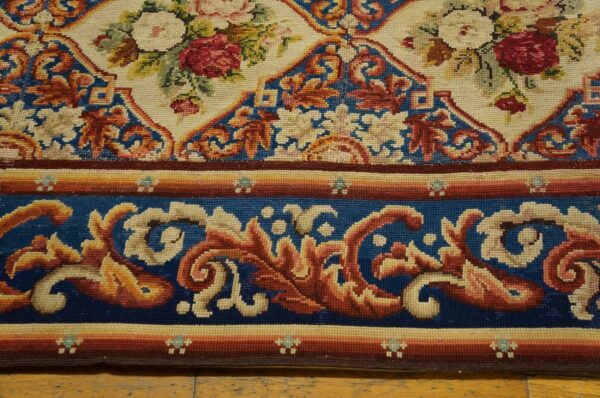 Close-up of a floral needlepoint rug border by rugs on net. By rugs on net