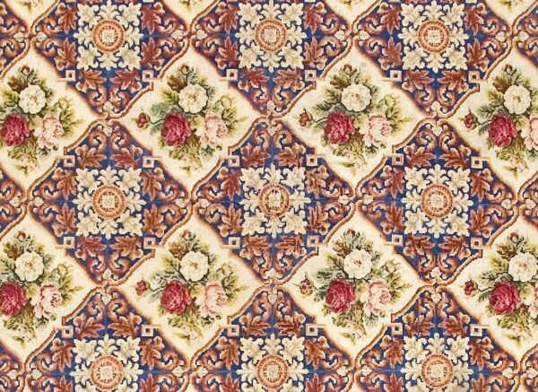 Close-up of a floral tapestry pattern featuring roses in cream and deep pink, set against a cream background framed by blue and brown scrollwork, by rugs on net