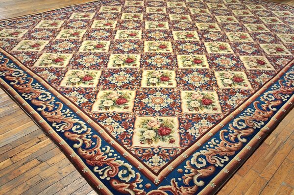 Close-up of a floral tapestry rug with blue borders by rugs on net