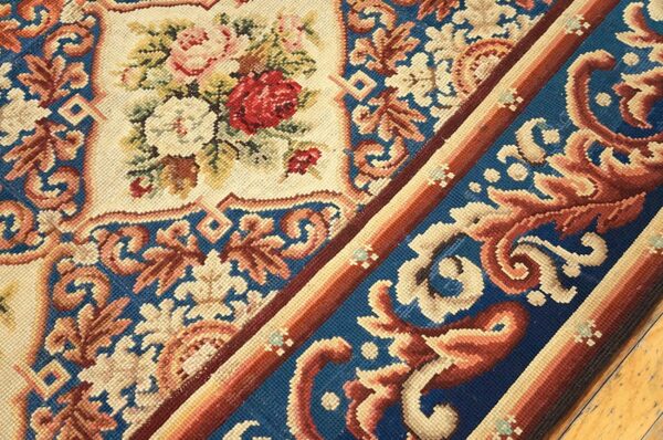 Close-up of a needlepoint rug featuring floral patterns and a blue border, by rugs on net