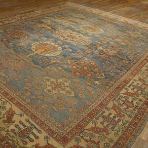 Close-up of a blue and tan antique rug with intricate patterns by Rugs On Net