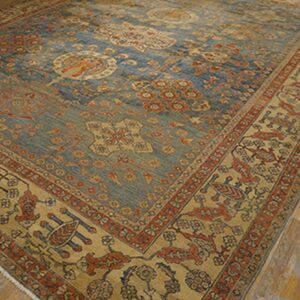 Close-up of a blue and tan Oriental rug with intricate patterns, by Rugs On Net